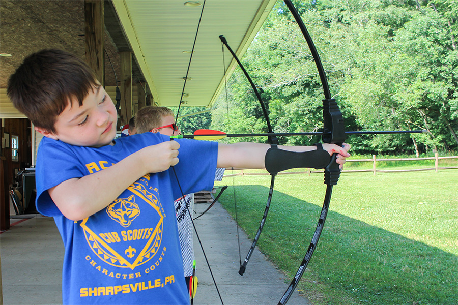 Cub Scout shooting bow and arrow Cub Scout shooting bow and arrow