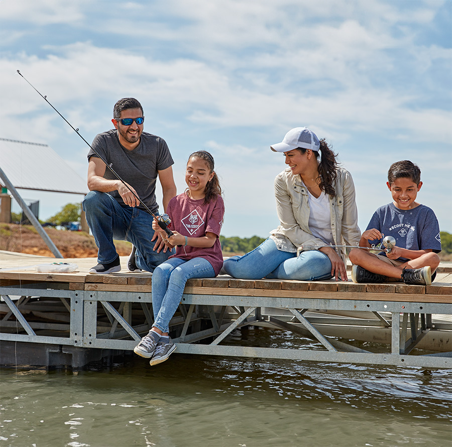 Scout family fishing off pier