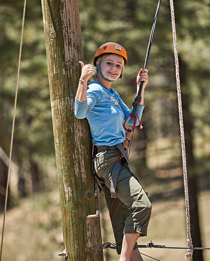 Scout on tree top course with thumbs up